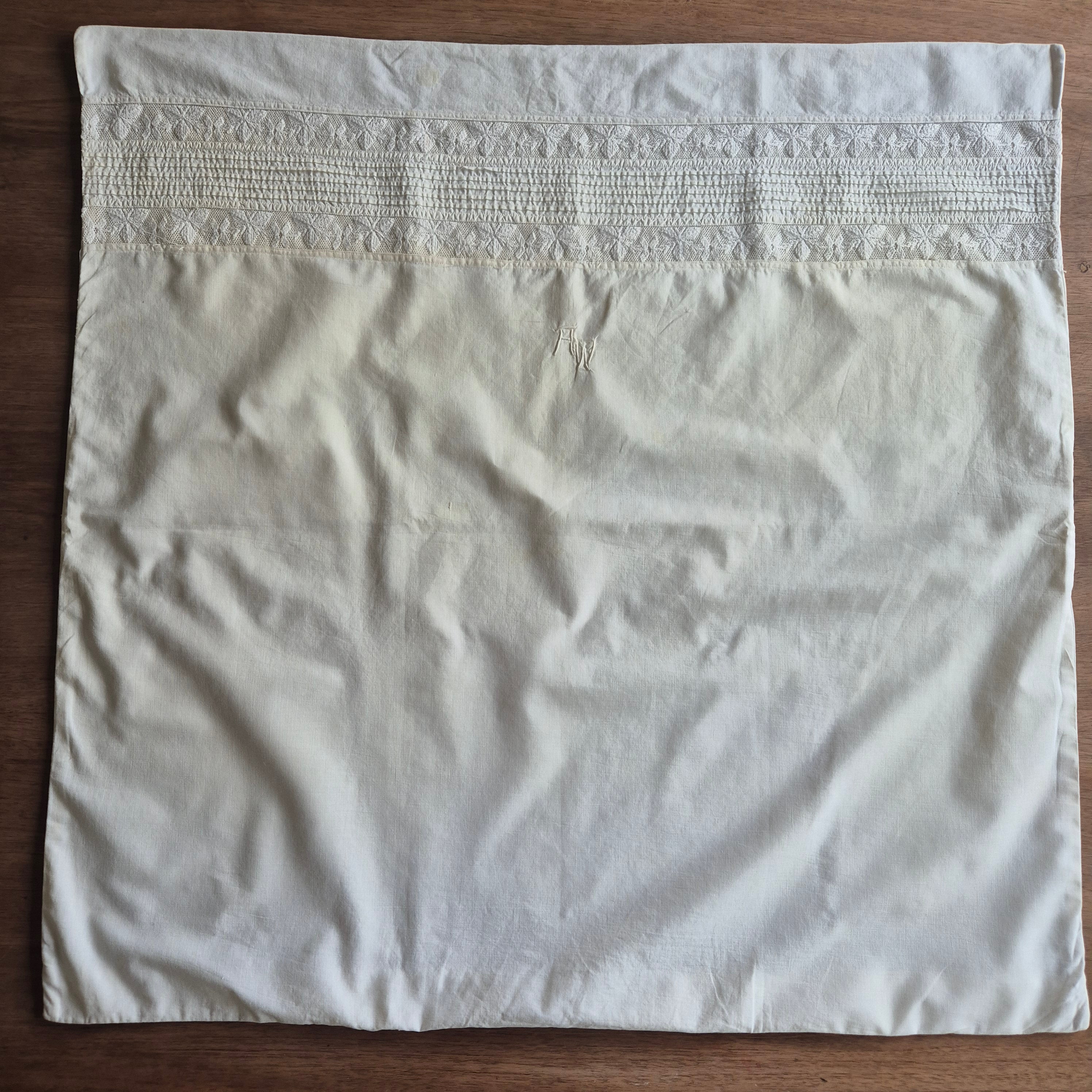 Stark vergilbter Kopfkissenbezug mit Monogram A.W. 75x70cm