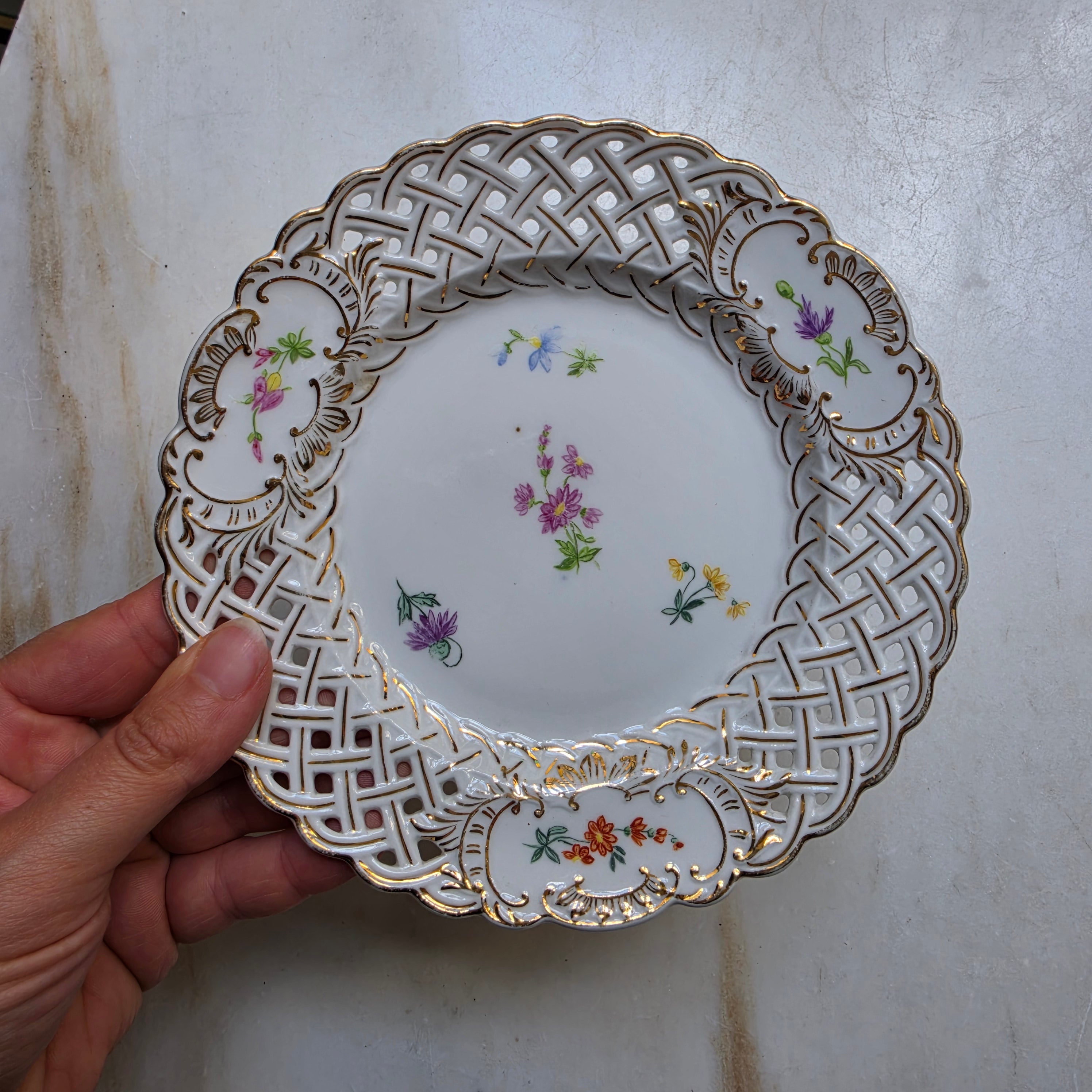 Antiker Durchbruchteller mit handgemalten Blumen – um 1900